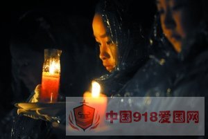 小学生代表在雨中手捧红烛。昨晚，南京大屠杀遇难同胞纪念馆集会广场举行“和平烛光祭”活动，国际友好人士及北京、沈阳、福建等地的代表与南京市小学生代表们一起，点亮代表悼念30万遇难同胞的3000支红烛。新华社发